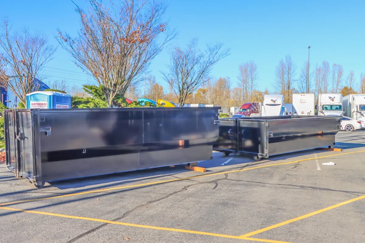 Professional dumpster rental service with roll-off container on residential driveway in Vermilion